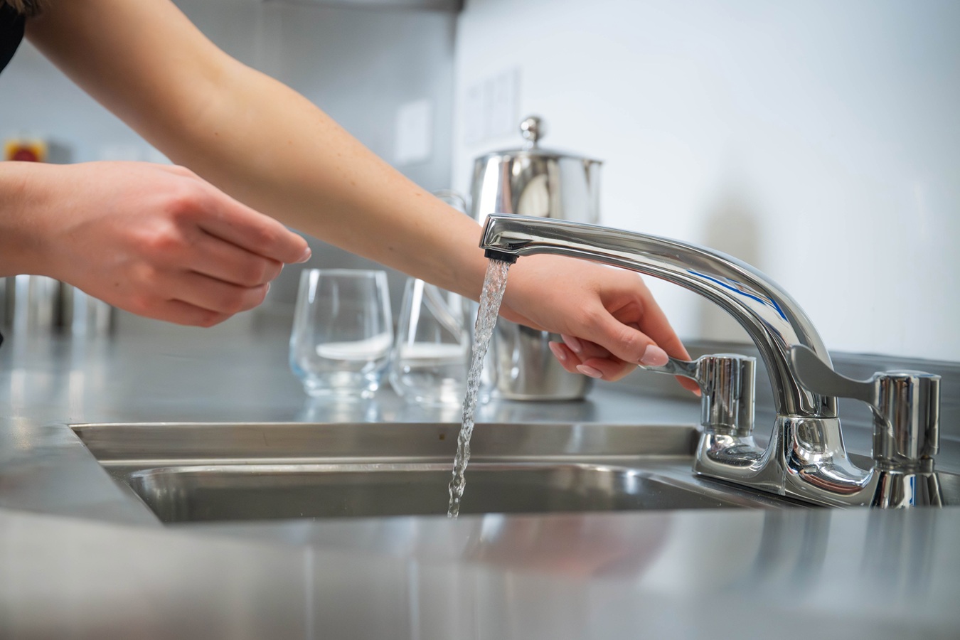 Someone turning on a tap
