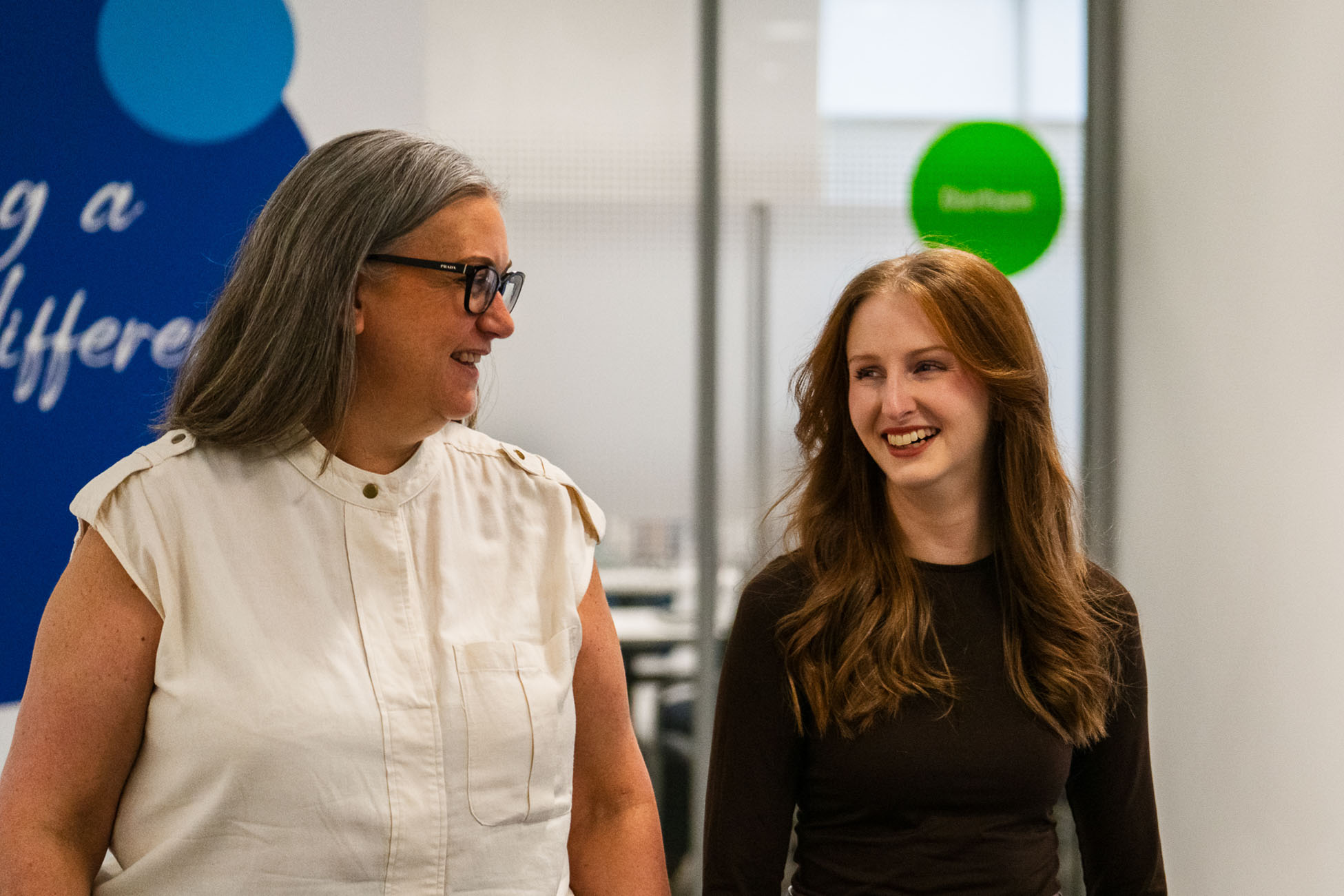 Two smiling women walking in Business Stream office space