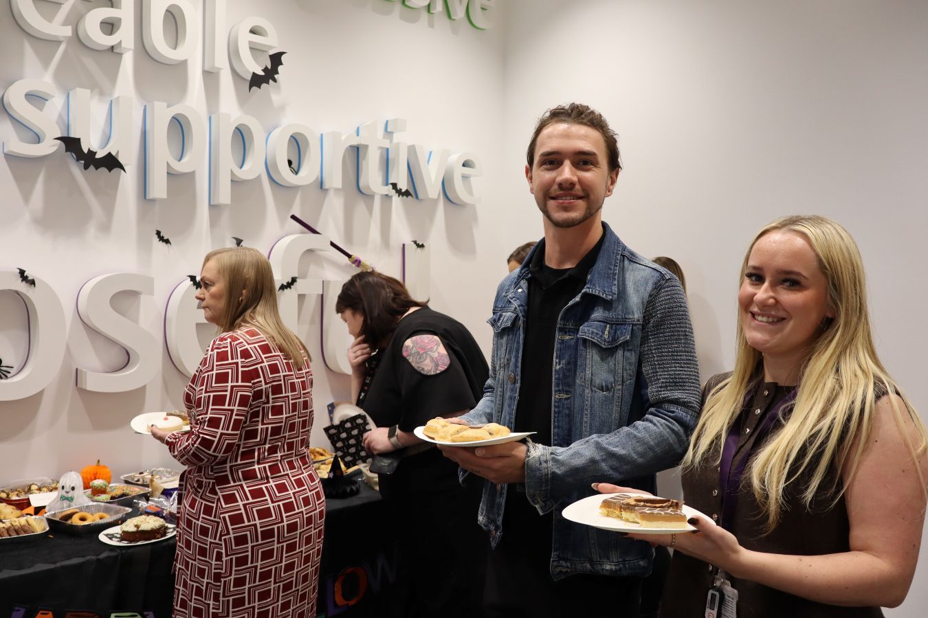 Business stream colleagues at a Halloween bake sale