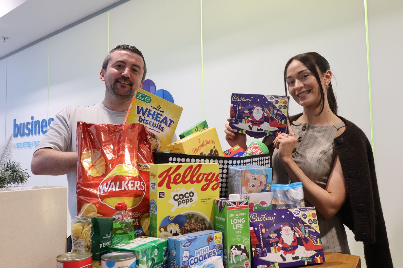 Two Business Stream colleagues with a selection of grocery donations