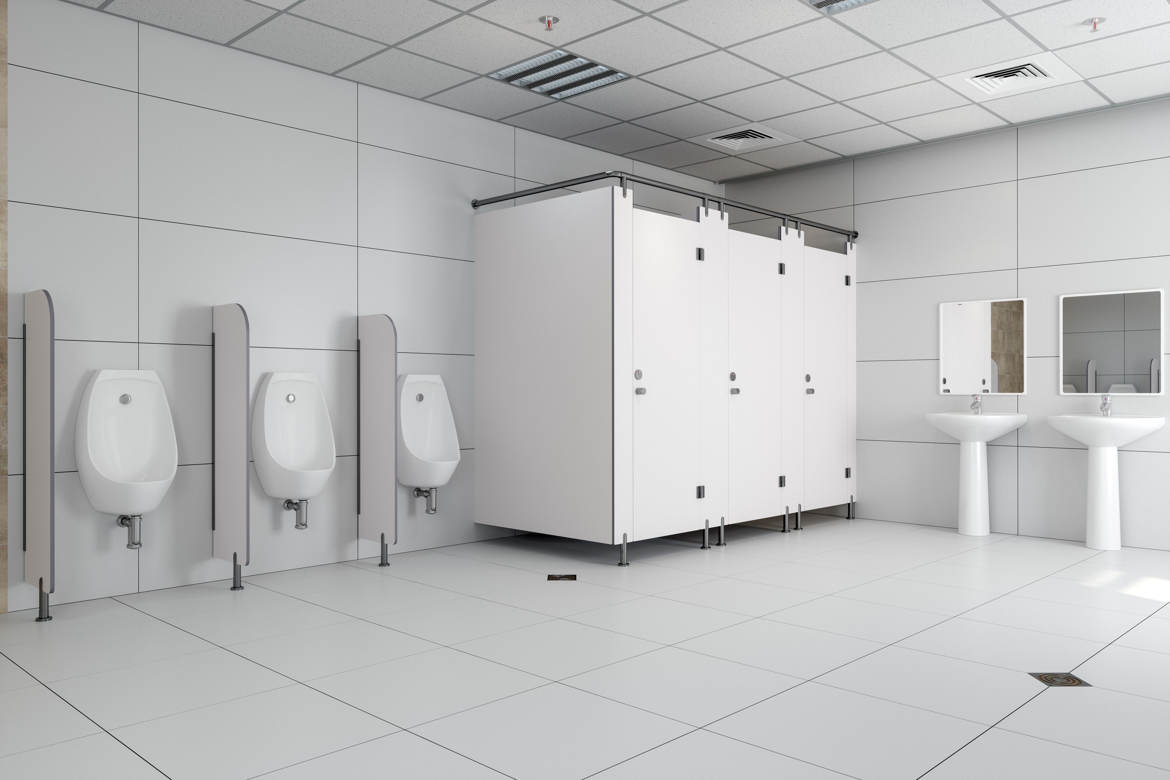 Public toilet in all white, showing cubicles and urinals