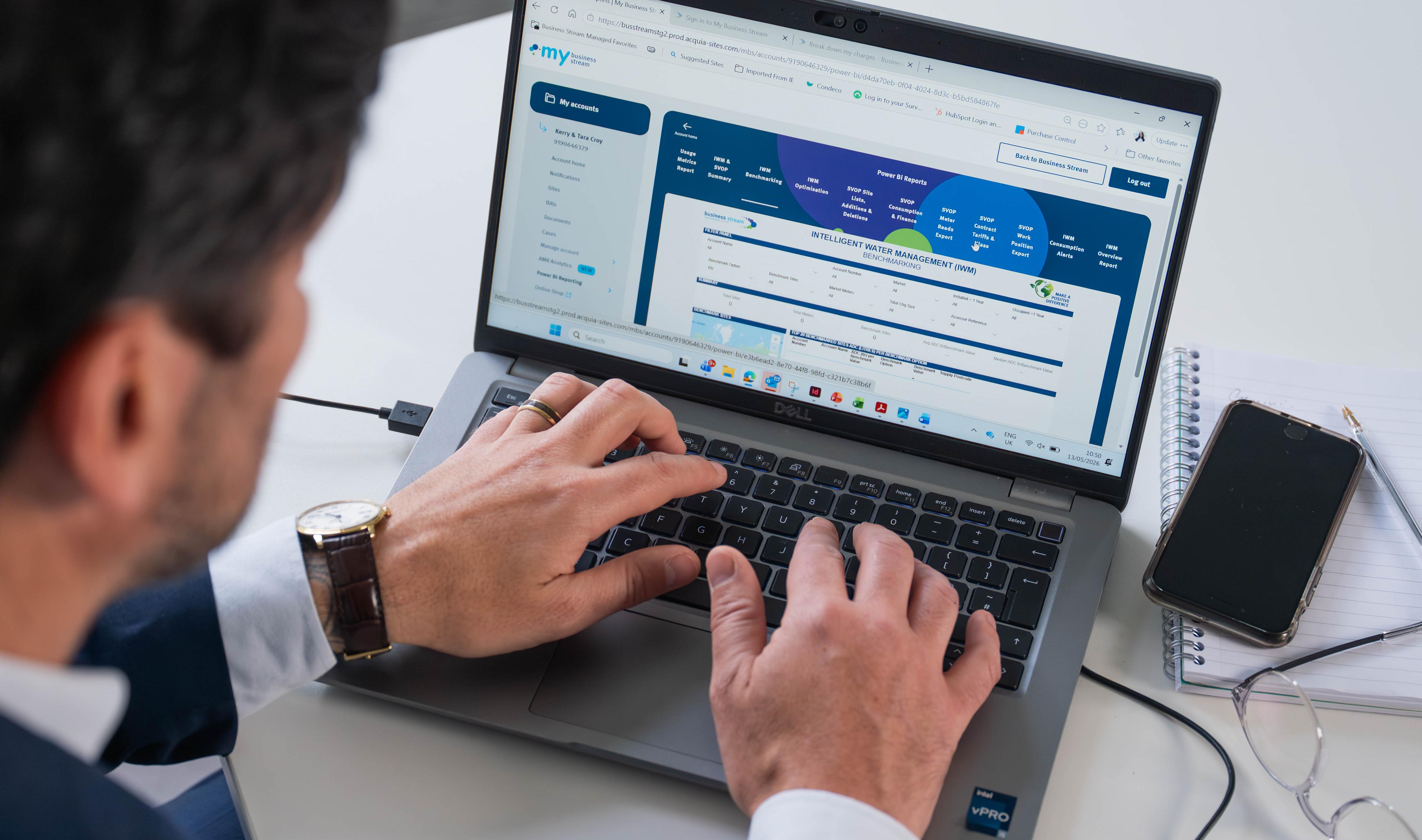 Looking over the shoulder of a man at a laptop reading data