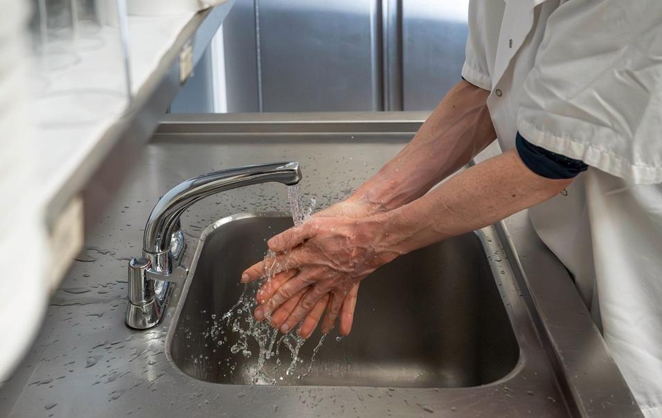 Man washing hands in commercial kitchen