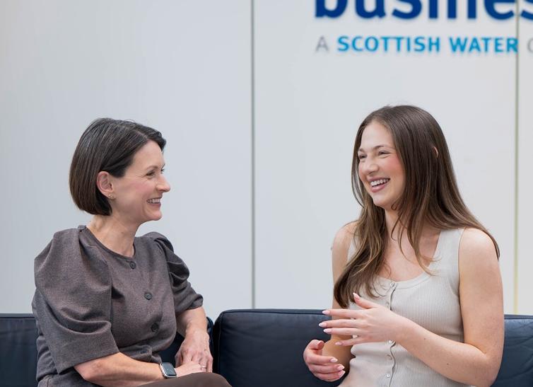 Two women chatting on a sofa