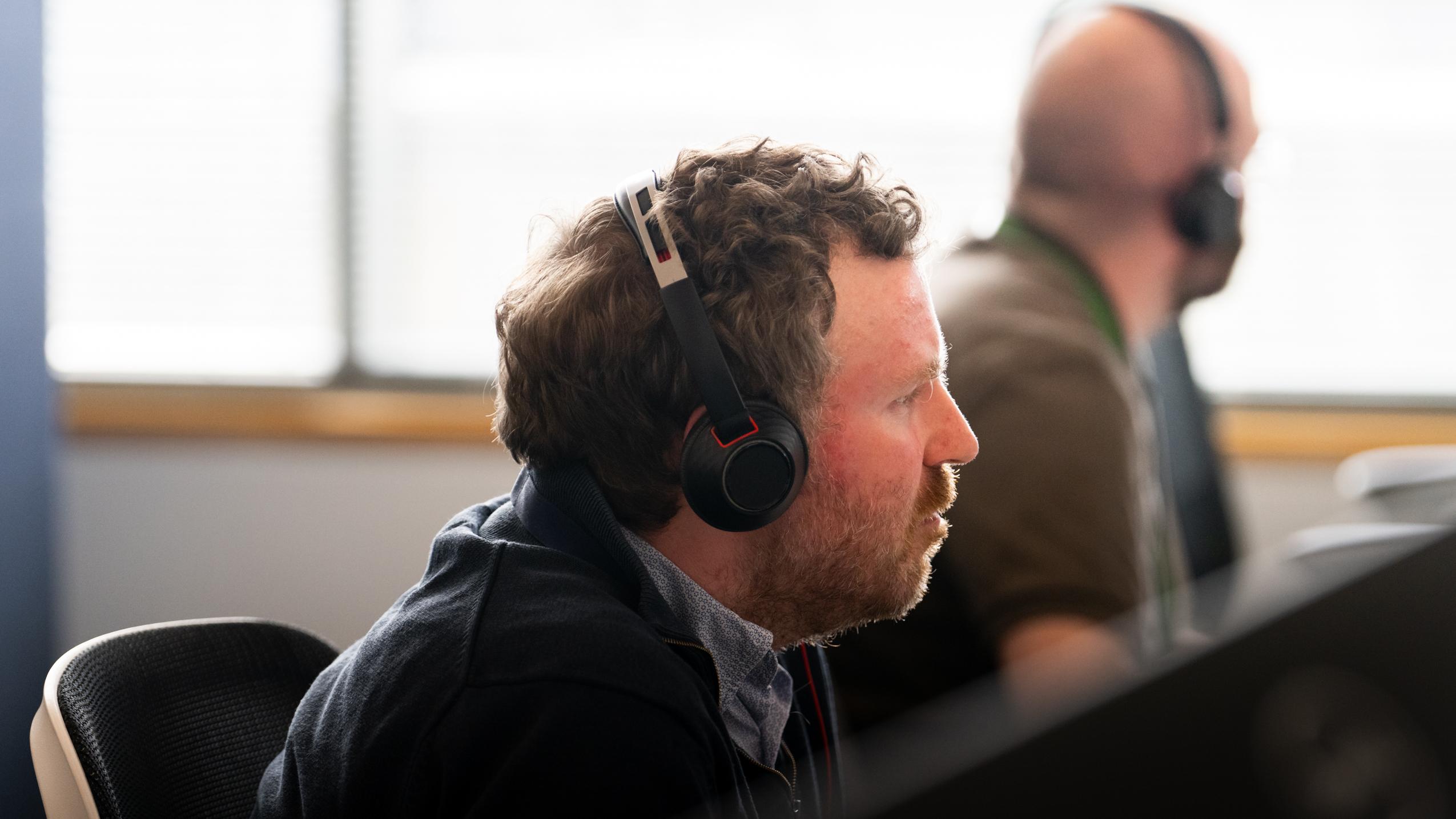 Man wearing headset advising a customer