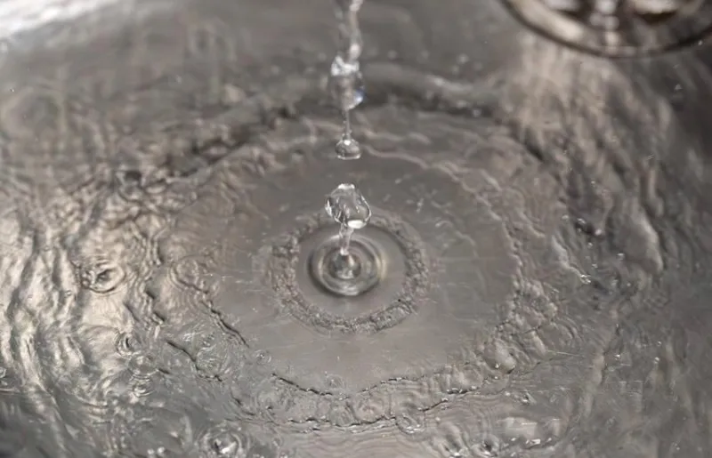 Water drops landing in a metallic sink